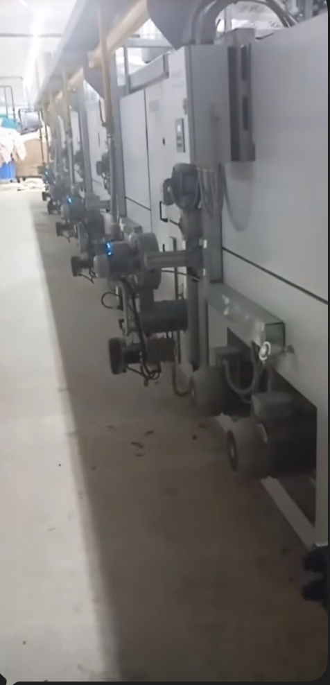 Row of soft-flow dyeing machines with valve controls